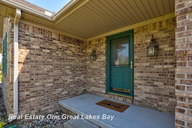 property entrance featuring brick siding