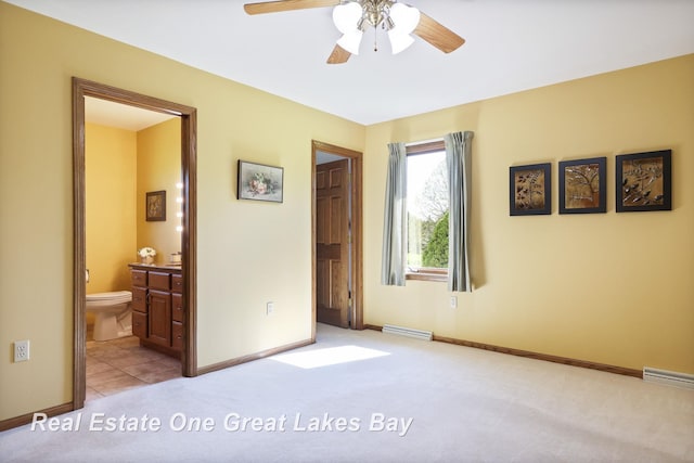 bedroom with light carpet, baseboards, and ensuite bath