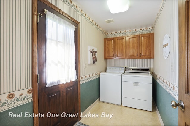 clothes washing area featuring independent washer and dryer, cabinet space, wallpapered walls, and baseboards