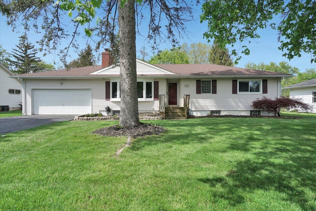 6128 Northrup Dr, Waterford, MI 48329 - single story home featuring a chimney, an attached garage, asphalt driveway, and a front lawn