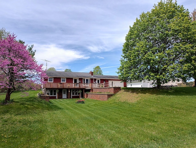 2660 Barber Rd, Grass Lake, MI 49240 - back of house with a yard, a deck, a chimney, and brick siding