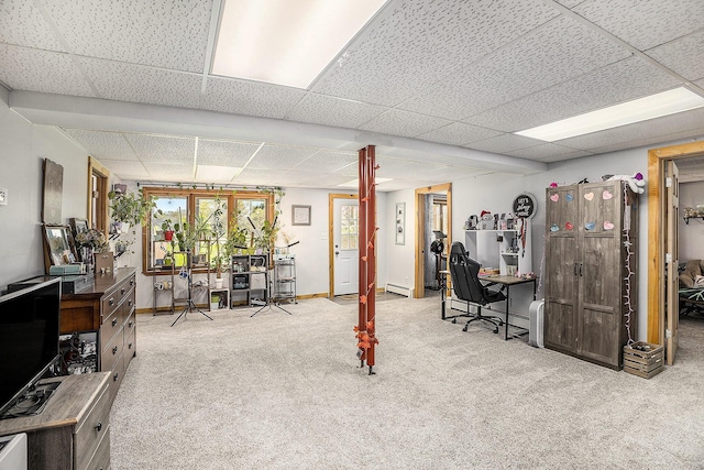 2660 Barber Rd, Grass Lake, MI 49240 - below grade area featuring a paneled ceiling, a desk, carpet, a baseboard radiator, and baseboards