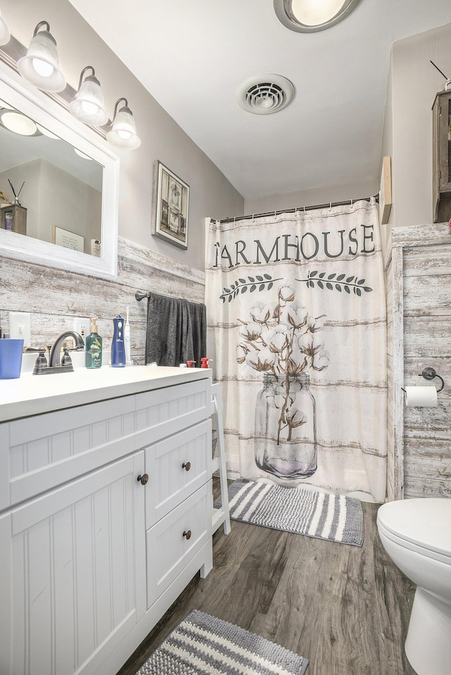 2660 Barber Rd, Grass Lake, MI 49240 - full bathroom featuring wood finished floors, vanity, toilet, and curtained shower