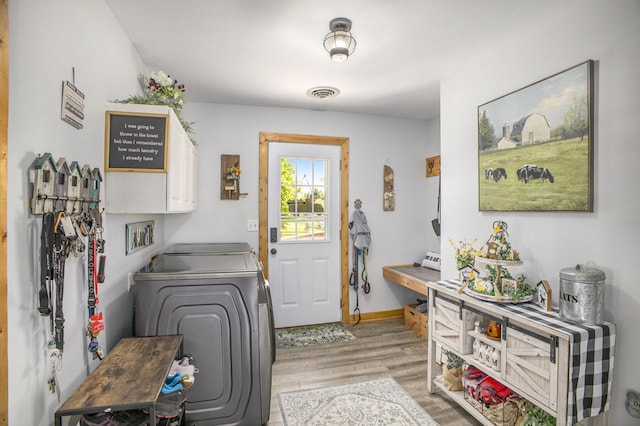 2660 Barber Rd, Grass Lake, MI 49240 - clothes washing area featuring light wood finished floors, cabinet space, and baseboards