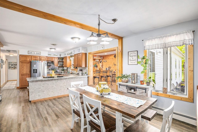 2660 Barber Rd, Grass Lake, MI 49240 - dining area featuring light wood finished floors and baseboard heating