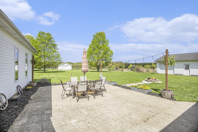 2660 Barber Rd, Grass Lake, MI 49240 - view of patio with an outdoor fire pit, outdoor dining space, and an outbuilding