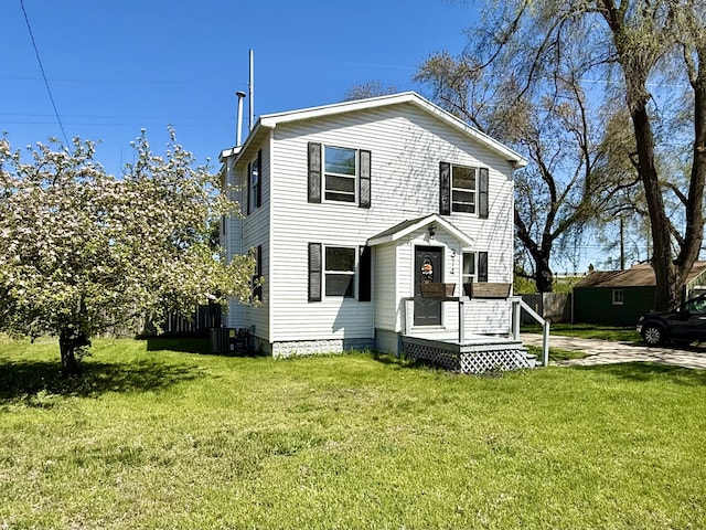 traditional-style house with a front lawn and central air condition unit