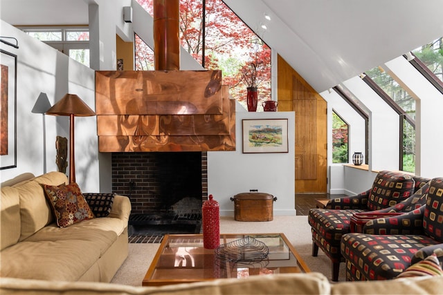 carpeted living area featuring healthy amount of natural light, a high ceiling, a fireplace, and baseboards