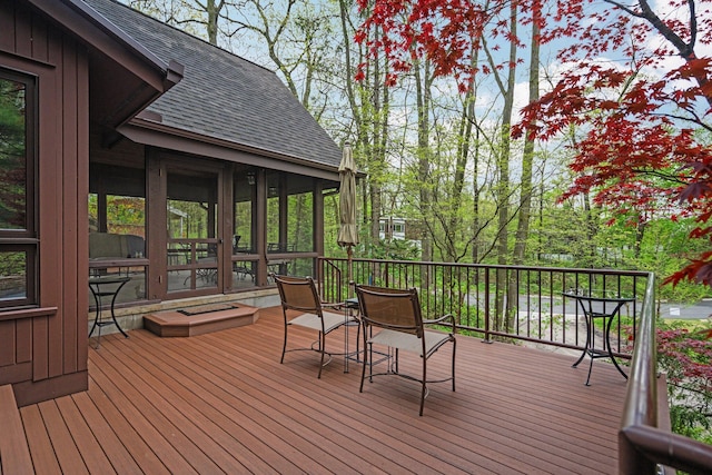 wooden deck with a sunroom