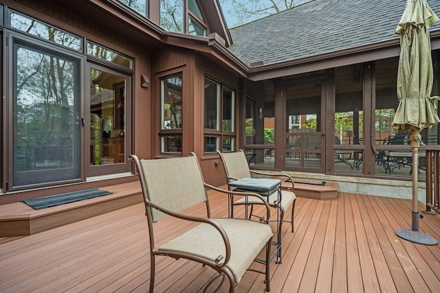 wooden deck with a sunroom