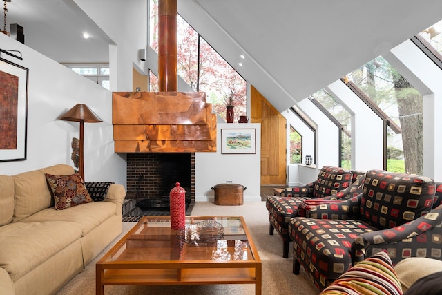 living area with a high ceiling, carpet floors, a fireplace, and recessed lighting
