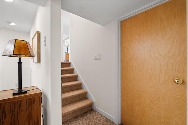 stairway with baseboards and recessed lighting