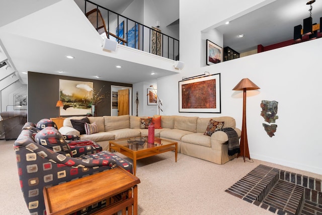 living area with carpet floors, a high ceiling, and recessed lighting