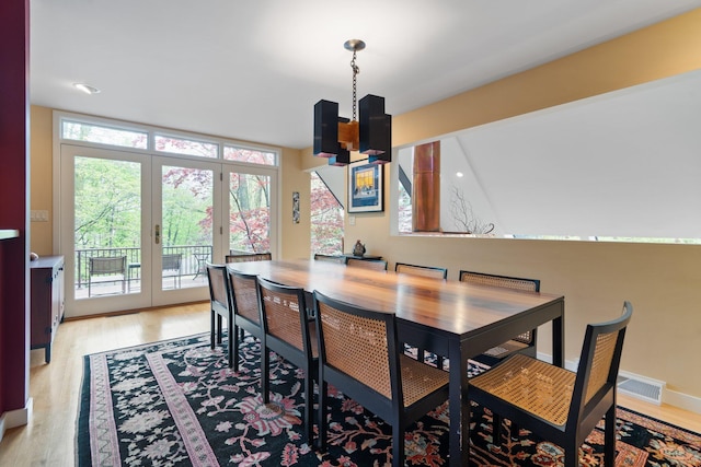 dining area featuring light wood-style flooring and french doors