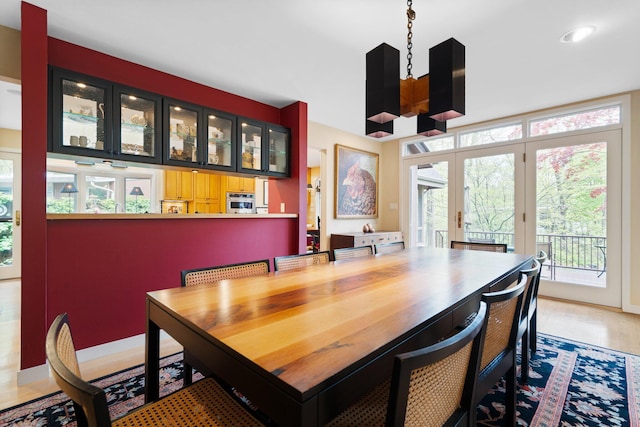 dining room with french doors, plenty of natural light, and recessed lighting
