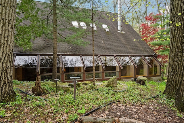back of property featuring a shingled roof