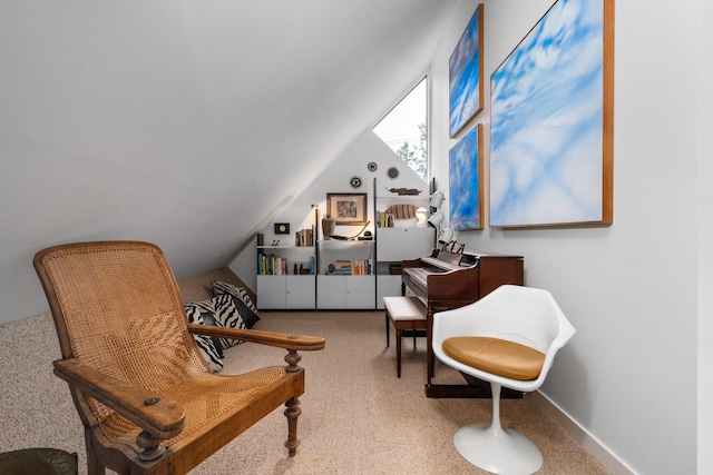 sitting room with carpet floors and vaulted ceiling