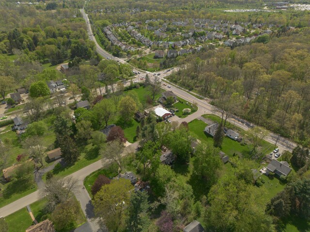 aerial view of property's location with a forest and nearby suburban area