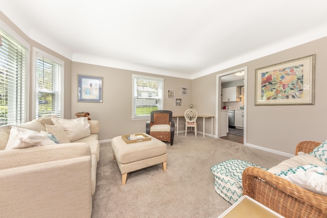 living room with light carpet and baseboards