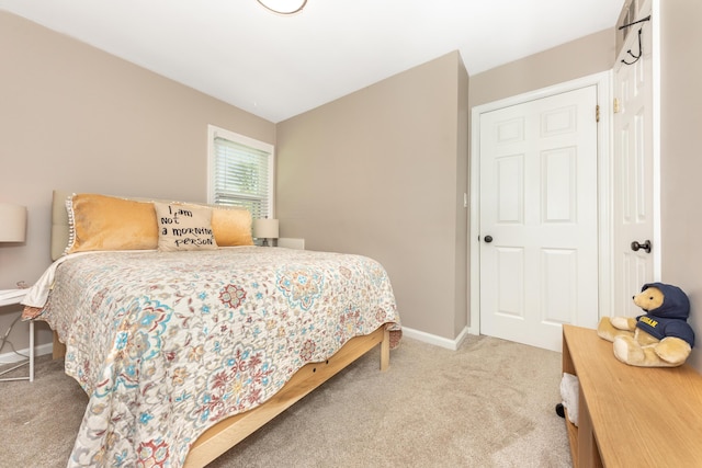 carpeted bedroom featuring baseboards