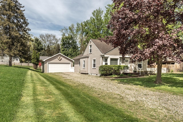 view of front of house featuring an outdoor structure, a garage, driveway, and a shingled roof