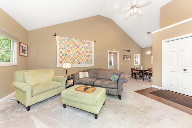 living area featuring a ceiling fan, carpet flooring, high vaulted ceiling, and baseboards