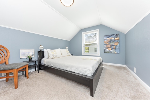 bedroom featuring light colored carpet, lofted ceiling, and baseboards