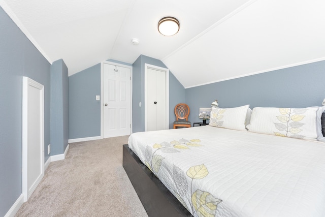 bedroom with carpet, lofted ceiling, and baseboards