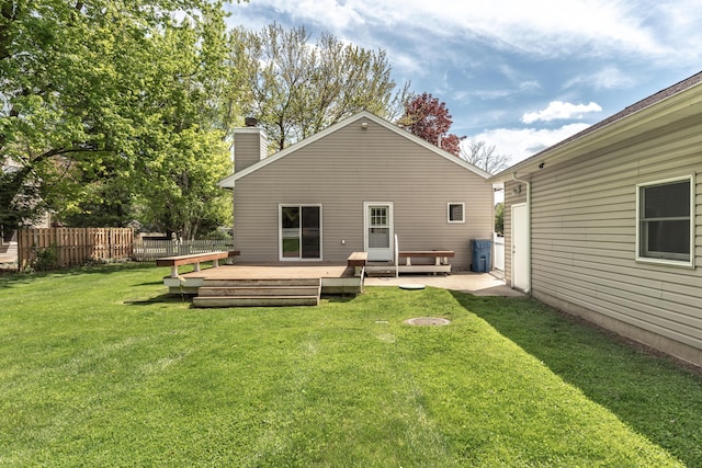 back of property featuring a chimney and a deck