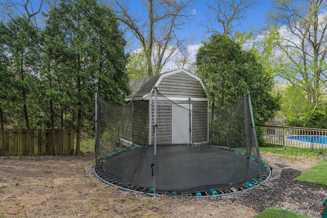 2394 Cedar Crest Dr NE, Grand Rapids, MI 49525 - view of shed featuring a trampoline and fence