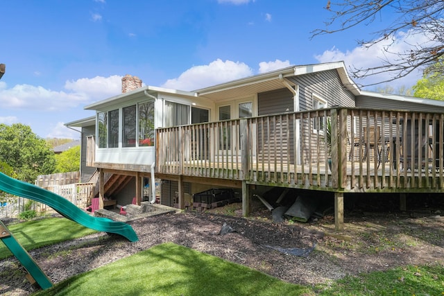 2394 Cedar Crest Dr NE, Grand Rapids, MI 49525 - back of property featuring a chimney, a sunroom, a deck, and a playground