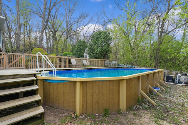 2394 Cedar Crest Dr NE, Grand Rapids, MI 49525 - swimming pool featuring a deck and view of wooded area
