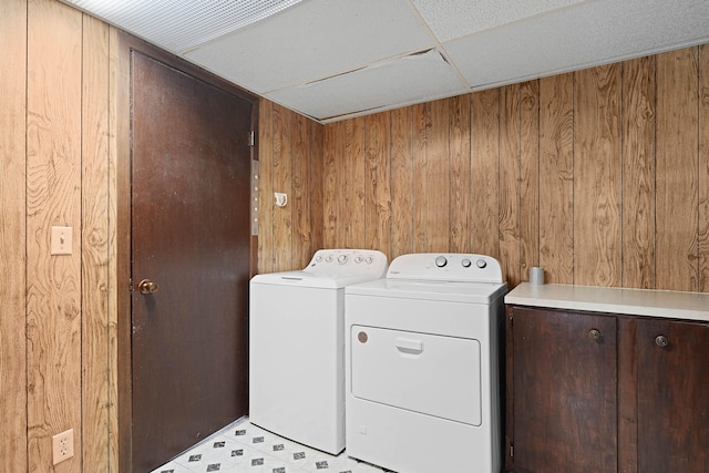 2394 Cedar Crest Dr NE, Grand Rapids, MI 49525 - laundry area featuring wood walls and washing machine and dryer