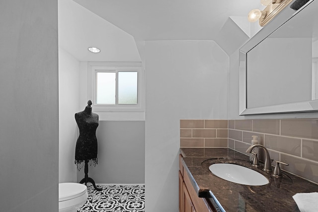 2394 Cedar Crest Dr NE, Grand Rapids, MI 49525 - bathroom featuring backsplash, toilet, and vanity
