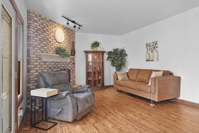 2394 Cedar Crest Dr NE, Grand Rapids, MI 49525 - living room with wood finished floors, baseboards, and track lighting