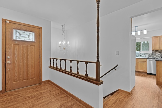 2394 Cedar Crest Dr NE, Grand Rapids, MI 49525 - entrance foyer featuring light wood-style floors, baseboards, and a chandelier