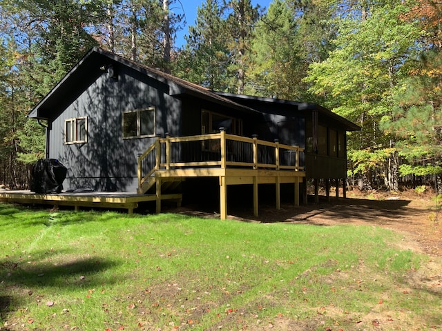 15205 Riverview Rd SE, Grayling, MI 49738 - rear view of property with a lawn and a deck