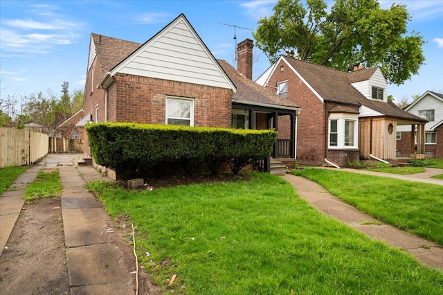 bungalow featuring brick siding and a chimney