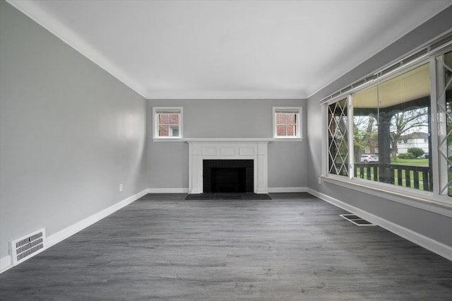 unfurnished living room with plenty of natural light, a brick fireplace, baseboards, and ornamental molding