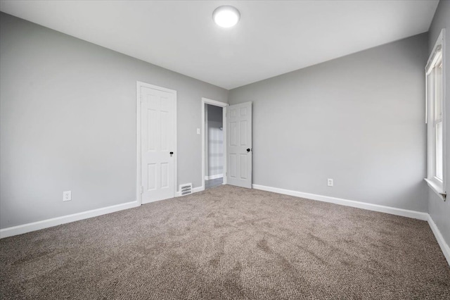 unfurnished bedroom with carpet and baseboards