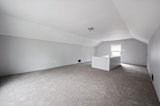 bonus room featuring lofted ceiling and carpet flooring