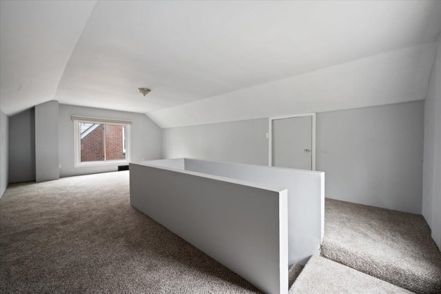 bonus room with carpet and vaulted ceiling