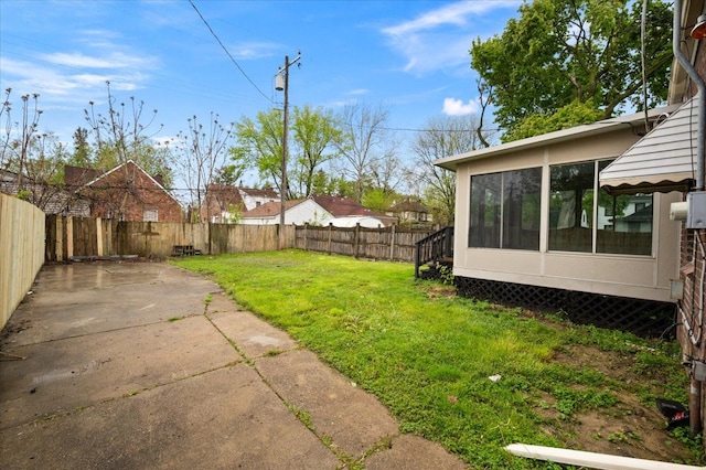 view of yard with a patio and a sunroom