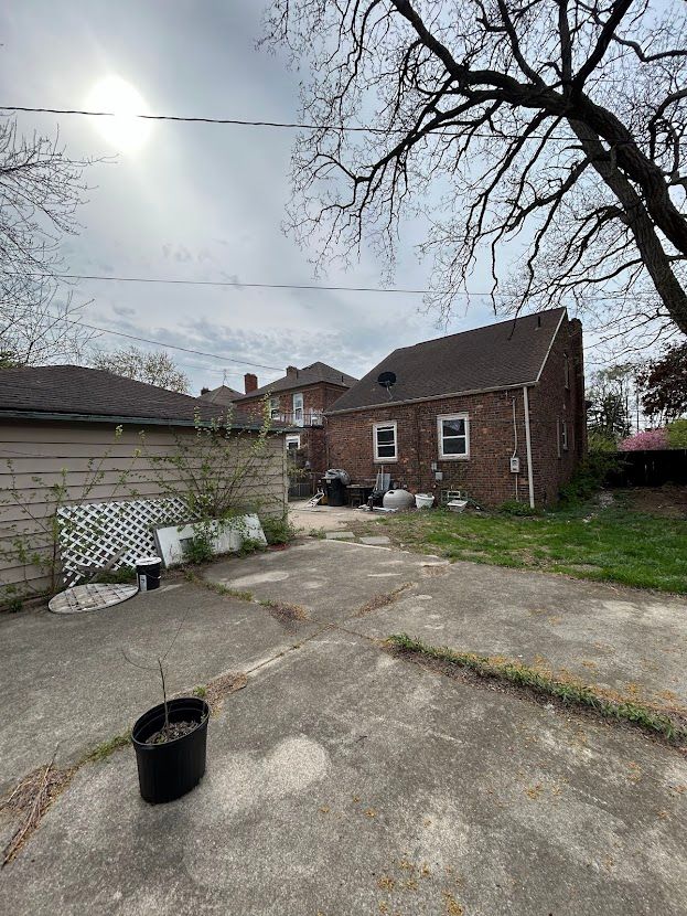 back of house featuring a patio area and brick siding