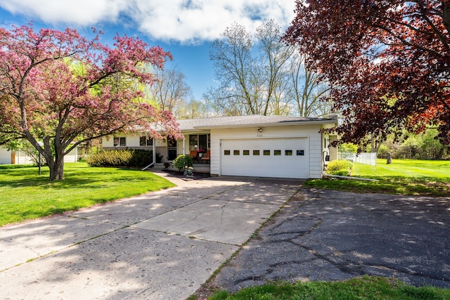 5200 N Jennings Rd, Flint, MI 48504 - view of front of property featuring concrete driveway, a garage, and a front yard