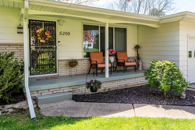 5200 N Jennings Rd, Flint, MI 48504 - doorway to property with a porch and a garage