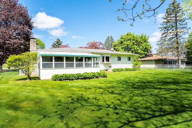 5200 N Jennings Rd, Flint, MI 48504 - rear view of house featuring a sunroom and a chimney