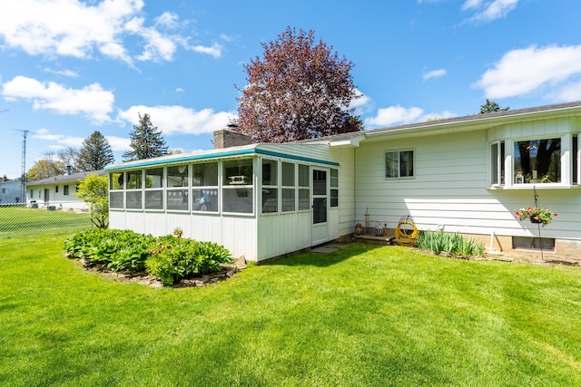 5200 N Jennings Rd, Flint, MI 48504 - back of house with a sunroom and a chimney