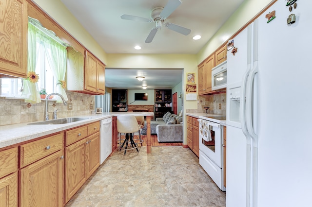 5200 N Jennings Rd, Flint, MI 48504 - kitchen featuring white appliances, a sink, open floor plan, ceiling fan, and tasteful backsplash
