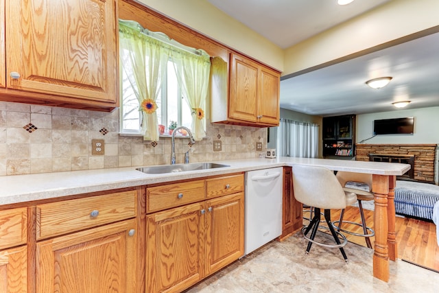 5200 N Jennings Rd, Flint, MI 48504 - kitchen with white dishwasher, a sink, a peninsula, and light countertops